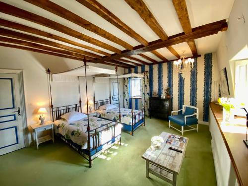 a large room with two beds and a table at Domaine Des Bidaudieres in Vouvray