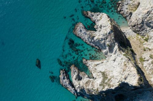 an aerial view of the ocean and a rocky coast at TUISuneo La Conchiglia - Adults Only in Capo Vaticano