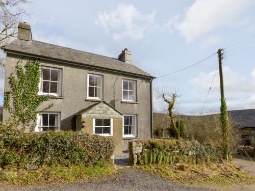 an old house with ivy on the side of it at Brimpts Cottage in Postbridge