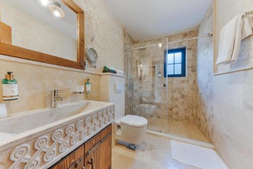 a bathroom with a shower and a sink and a toilet at Stara Čaršija Hotel & SPA in Bar