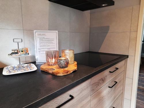 a counter with two candles and a plate of food at Secret Wellness Boszicht in Holten