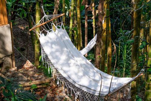 a hammock in the middle of a garden at Finca Colibrí Zafiro, Altos del Rosario in Cali