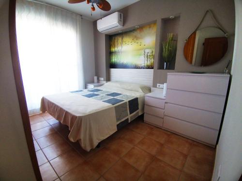 En eller flere senge i et værelse på Adosado Alcossebre Vacaciones
