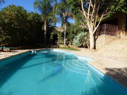 a large blue swimming pool in a yard at Agadir-Taghazout Magnifique Villa Dar Lina 4 etoiles in Agadir