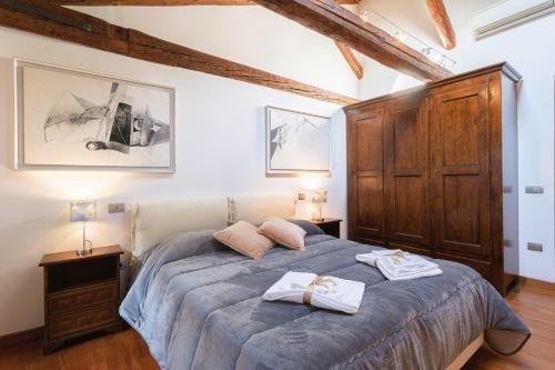 a bedroom with a bed with two towels on it at San Marco Luxury Loft with Terrace in Venice