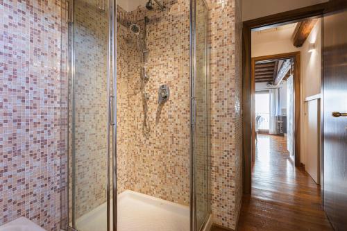 a shower with a glass door in a bathroom at San Marco Luxury Loft with Terrace in Venice