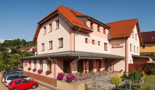 a building with cars parked in front of it at Penzion Krumlov - Massage studio in Český Krumlov