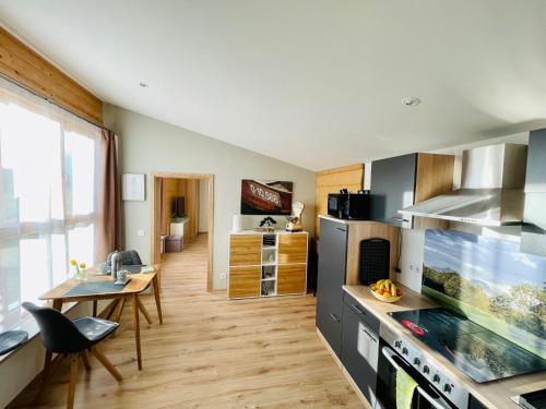 a kitchen with a table and a dining room at Römer Appartement mit sonniger Terrasse in Bad Reichenhall