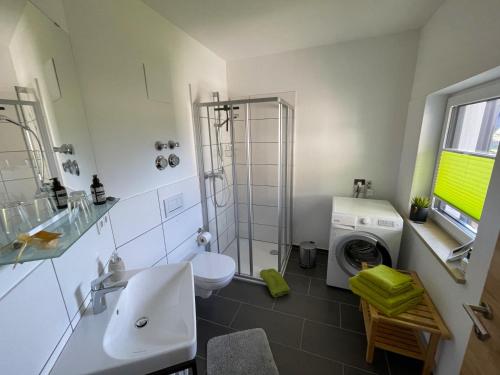 a bathroom with a sink and a washing machine at Römer Appartement mit sonniger Terrasse in Bad Reichenhall