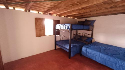 a room with two bunk beds and a window at Finca El Encanto del Guejar in Lejanías