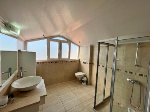 a bathroom with a sink and a shower and a toilet at Villa Valley Oludeniz, 4 Bedroom, Large Swimming Pool in Fethiye