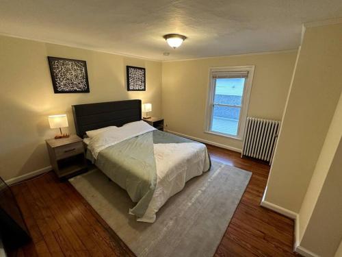 um quarto com uma cama grande e uma janela em The Yellow Door 3-bedroom downtown near VT&RU em Radford