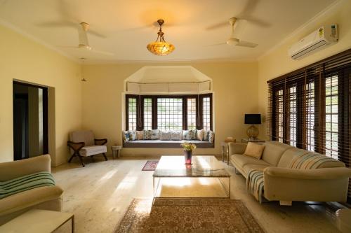 a living room with a couch and a table at Luho 187 in Bengaluru