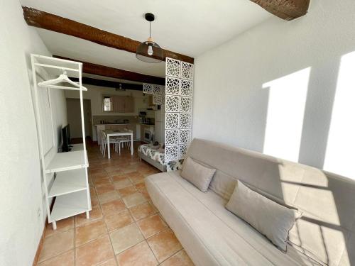 a living room with a couch and a table at Côté Place in Riez