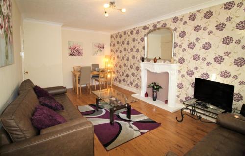 a living room with a couch and a fireplace at Boswell-Large Balcony Apartment-Town & Racecourse in Doncaster