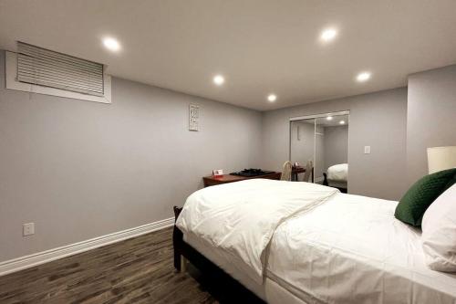 a bedroom with a large bed and a mirror at Pearson airport and Toronto cozy stay - 2 bedroom in Vaughan