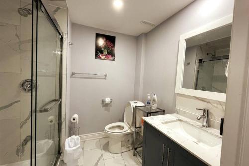 a bathroom with a toilet and a sink and a shower at Pearson airport and Toronto cozy stay - 2 bedroom in Vaughan