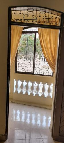 an open door with a window and a curtain at Piazza Granada in Cali