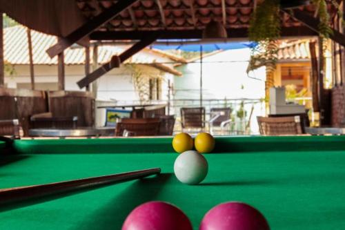 a pool table with balls on top of it at Pousada Casa da Penha in Abraão