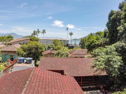 an overhead view of roofs of houses with palm trees at Pousada Casa da Penha in Abraão