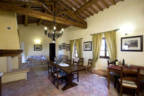 a living room with a table and chairs and a couch at Agriturismo Il Macchione in Pienza