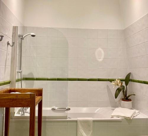 a white bathroom with a tub and a sink at Domaine Des Bidaudieres in Vouvray