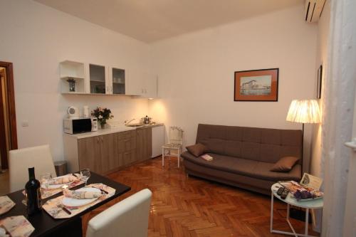 a living room with a couch and a table at Vincent apt. in old town centre in Zadar