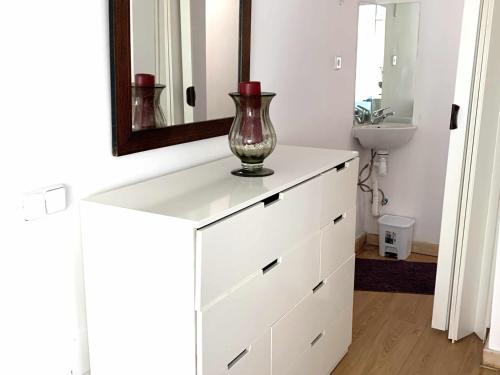a white dresser with a vase on it in a bathroom at Espectacular apartamento con piscina y garaje in Madrid