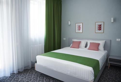 Postel nebo postele na pokoji v ubytování Astra Hotel