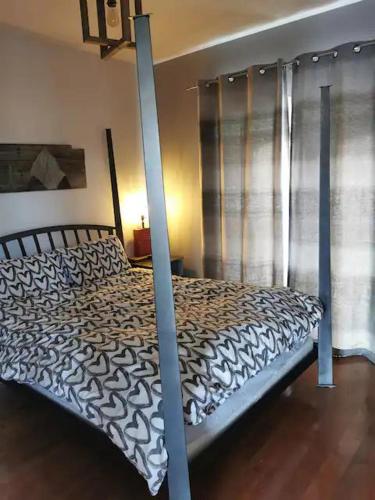 a bedroom with a large bed with a bed frame at Chalet Au petit Édouard (Mont Édouard) in LʼAnse-Saint-Jean