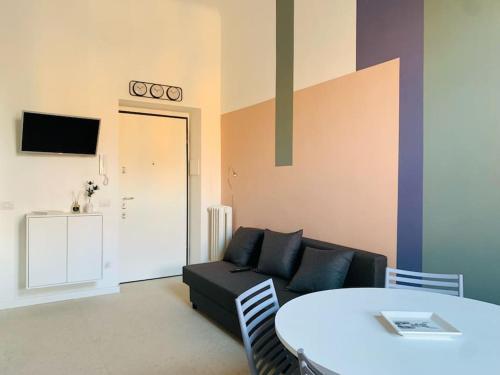 a living room with a couch and a table at Stylish flat in Porta Romana-Fondazione Prada in Milan