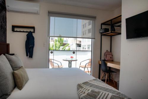 a bedroom with a bed and a view of a balcony at Lima 18 Boutique in Lima