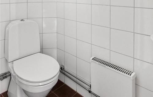 a white bathroom with a toilet and a radiator at 1 Bedroom Nice Home In Skåne Tranås in Skåne-Tranås