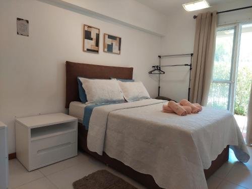 un dormitorio con una cama con un animal de peluche en Barra Garden Happy - Condomínio Barra Village Lakes tipo Resort - Recreio dos Bandeirantes, en Río de Janeiro