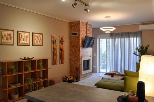 a living room with a couch and a fireplace at Apartment in Peania in Paianía