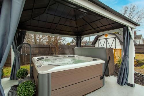 a hot tub in a gazebo at Blue Valley Inn - Hot Tub & Spacious Play Area! in Knoxville