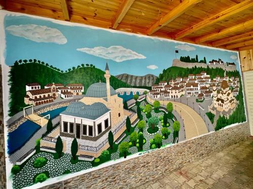 a wall with a mural of a resort at Hotel Vila Mimani in Berat