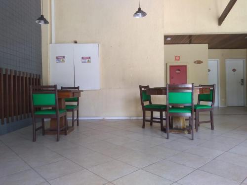 a room with chairs and tables and a whiteboard on the wall at Hotel Pousada do Sol in Aracaju