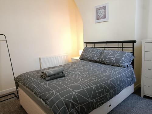 a bedroom with a bed with two pillows on it at Bright, Comfortable Home, Convenient for City Centre in Liverpool