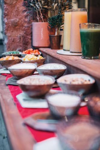 a table with bowls and plates of food on it at LOtel-Casa Arca in San Miguel de Allende
