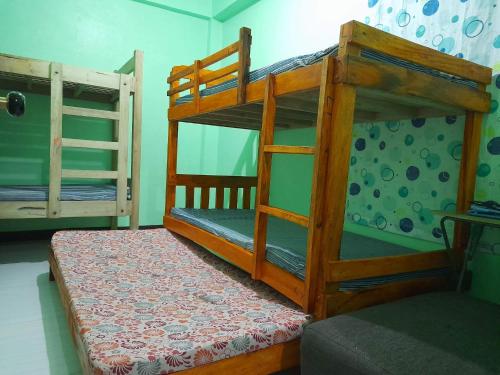 a bedroom with two bunk beds in a room at Baguio Transient in Baguio