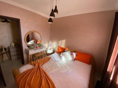 a bedroom with a bed and a mirror at NB Marrakech in Marrakesh