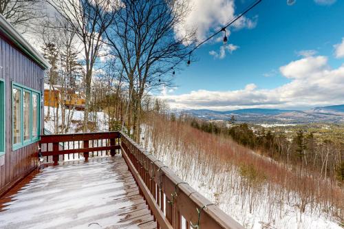 a balcony of a house with snow on the ground at Amazing View Retreat Home in Campton