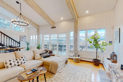 a living room with a couch and a table at Amazing View Retreat Home in Campton