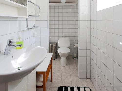 a white bathroom with a sink and a toilet at Holiday home in Hamburgsund 2 in Gerlesborg