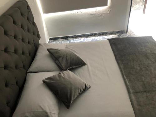a bed with two pillows on it in a room at HospedajeLR in Barrancabermeja
