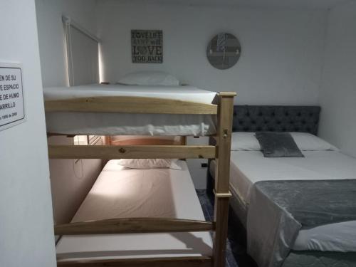 two bunk beds in a small room with at HospedajeLR in Barrancabermeja
