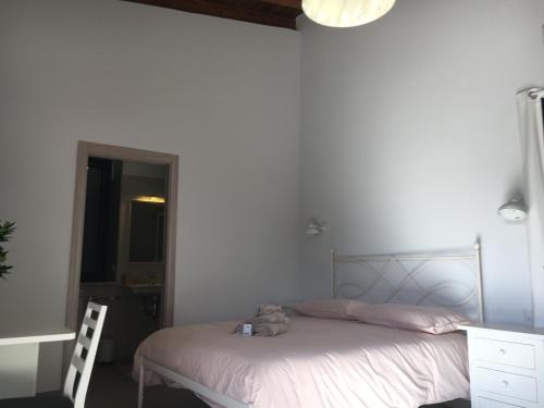 a bedroom with a bed with a teddy bear on it at Agriturismo Crilù in Milazzo