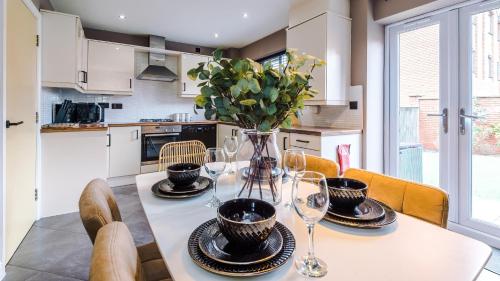 a kitchen with a table with glasses and a vase at Wharf View Townhouse Chester in Chester