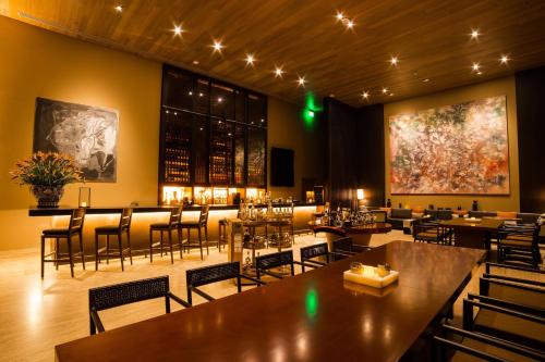 a restaurant with tables and chairs and a large painting on the wall at JW Marriott Los Cabos Beach Resort & Spa in San José del Cabo
